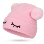 Closed eyes pom-pom beanie