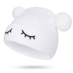 Closed eyes pom-pom beanie